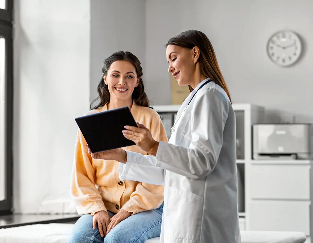 female doctor with tablet pc computer talking to smiling woman patient who is seeking a second opinion